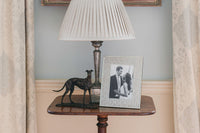 Textured Photo Frames displayed on a side table with a lamp and a decorative dog statue.