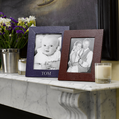 Jubilee Portrait Photograph Frame 10x8 with personalized engraving TOM, displaying two framed photos on a mantel.
