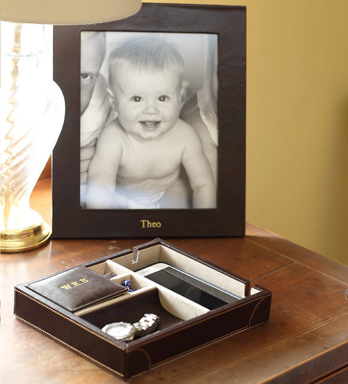 Chelsea Portrait Leather Photo Frame 10x8 with a black and white photo of a smiling baby and a personalized engraving
